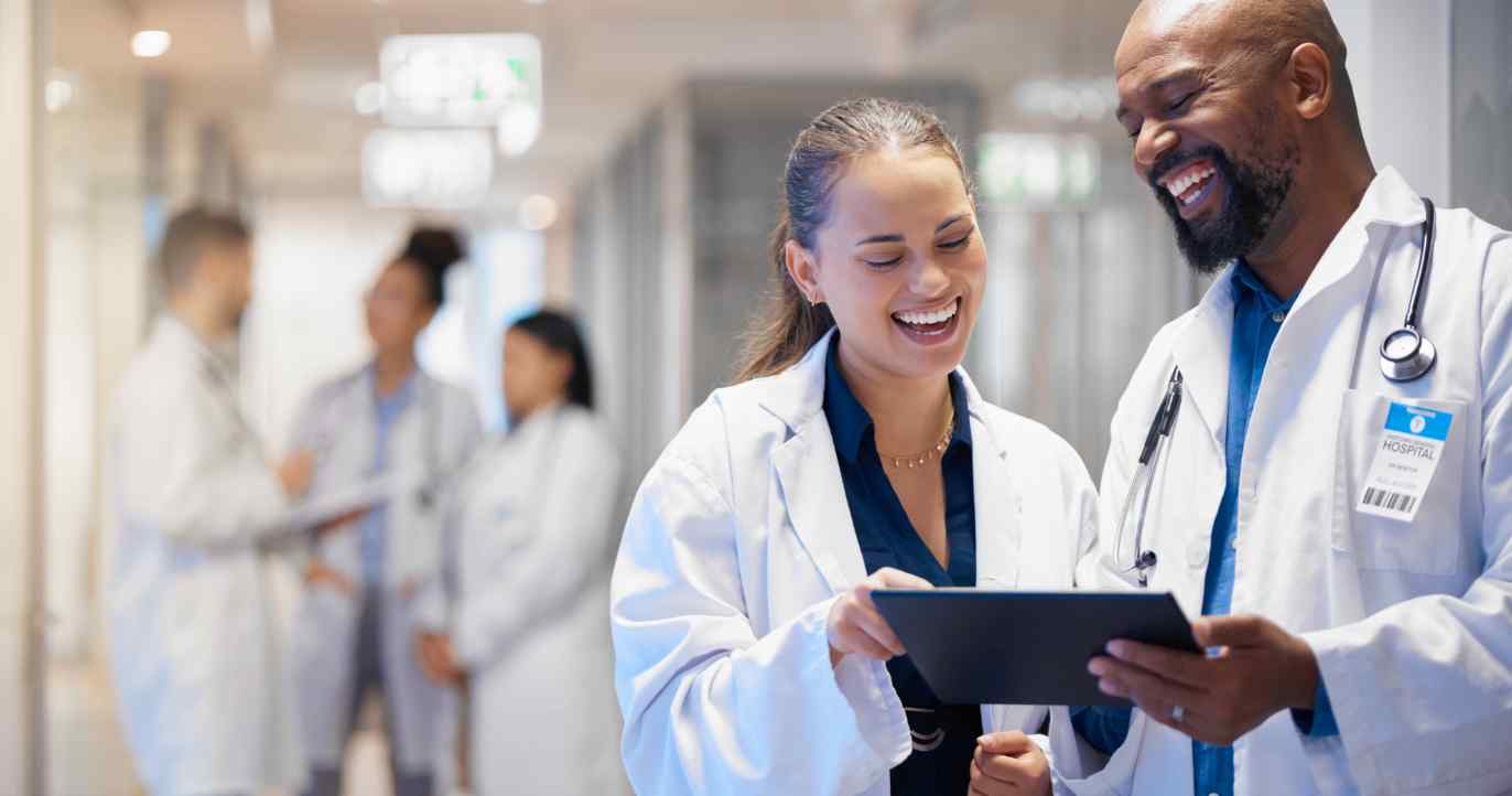 Doctors looking at a tablet