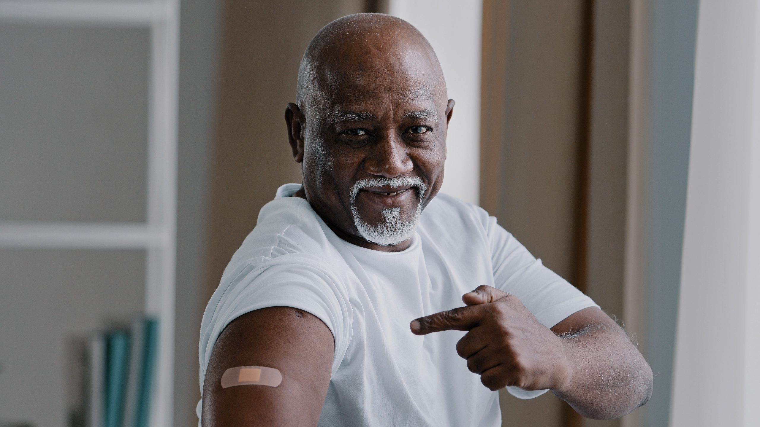Man with bandage on his arm that was vaccinated against COVID-19